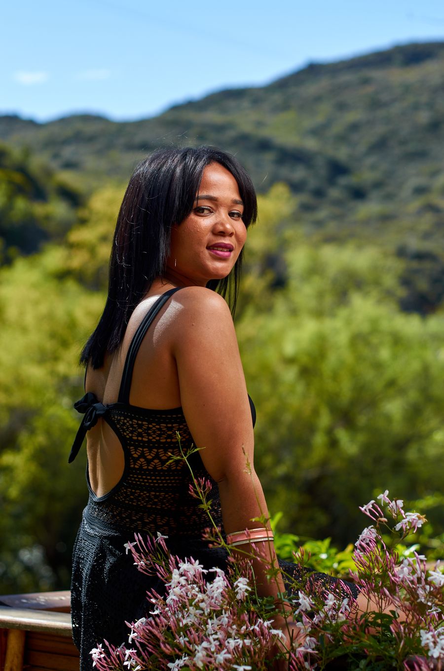 Lucia Brooks smiling among flowering branches